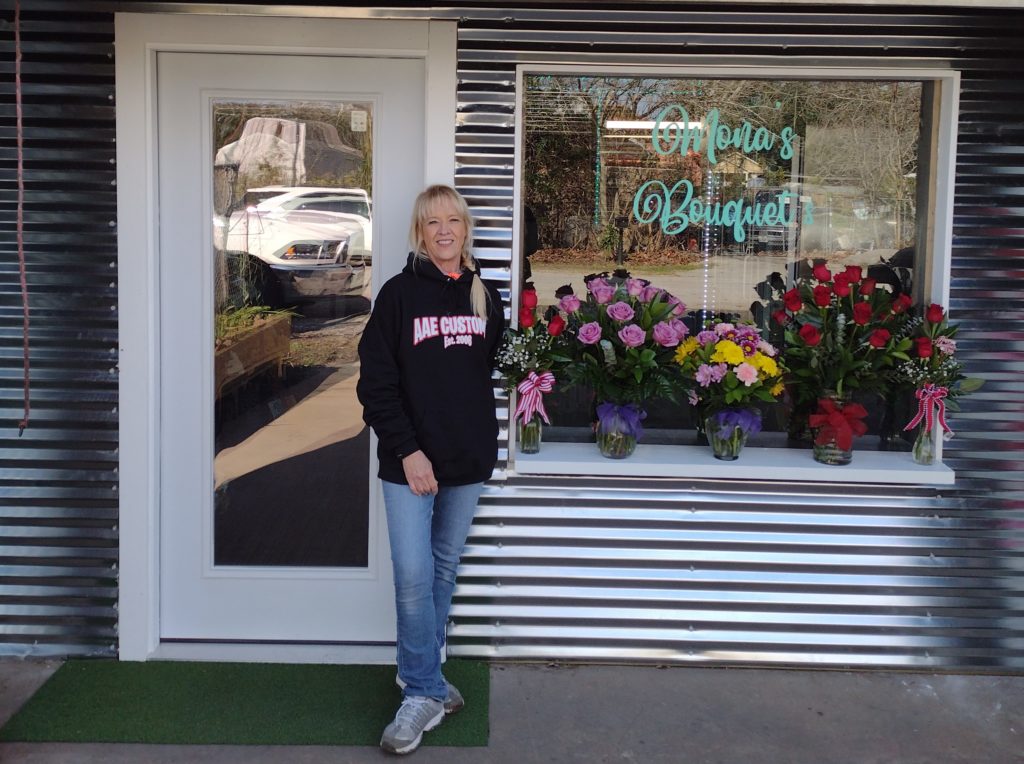 Mona in front of her shop.