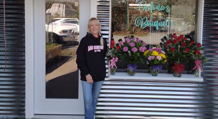 Mona in front of her shop.